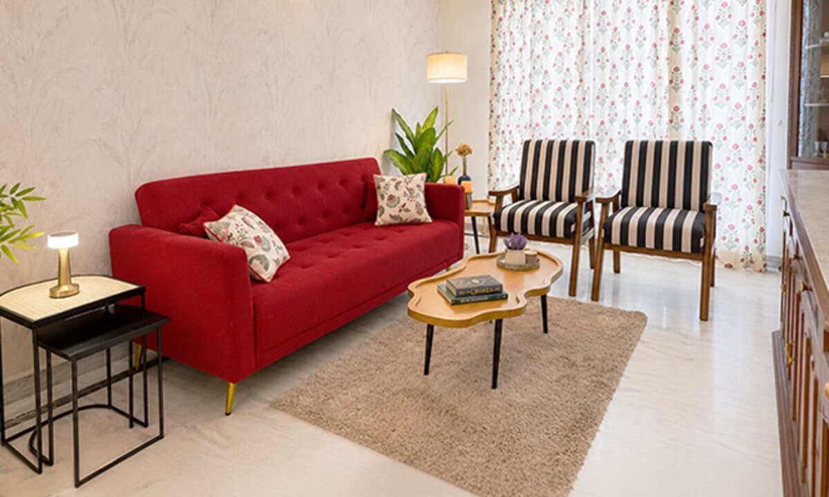 Furnished Airbnb living room with a red sofa